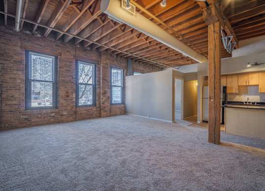 A large empty room with a wooden ceiling and white walls.