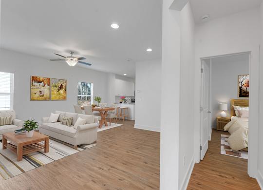 A living room with a white couch and a wooden coffee table.