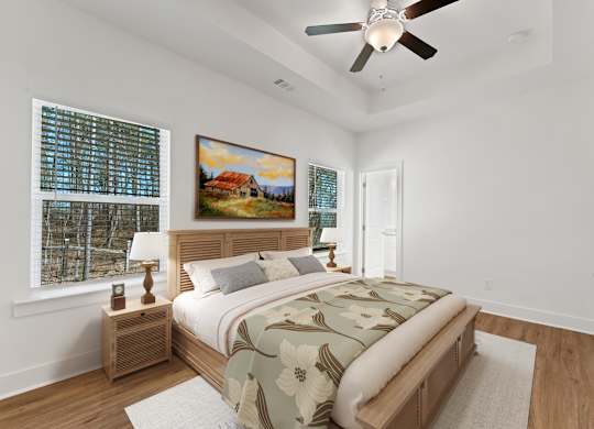 A bedroom with a large bed and a painting on the wall.