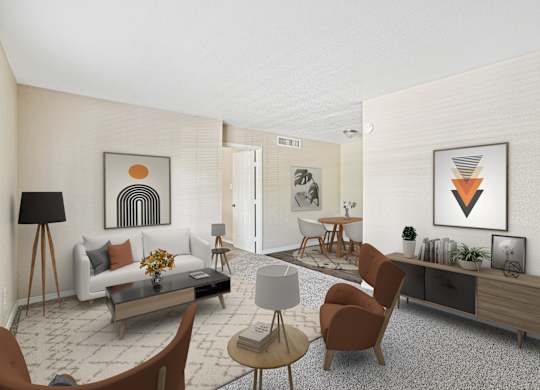 A living room with a white couch, a coffee table, and a few chairs.