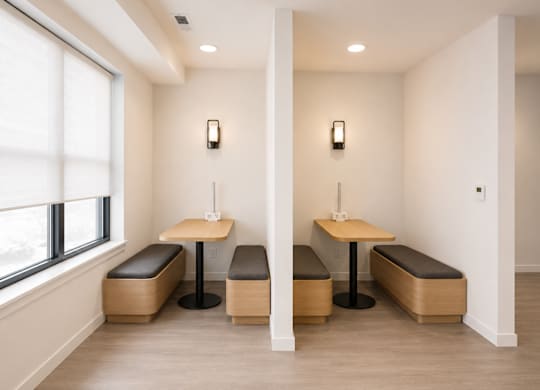 A room with two tables and two benches.