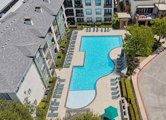 A large swimming pool surrounded by apartment buildings.