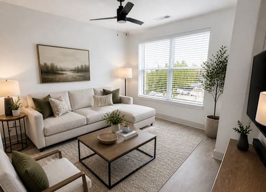 A living room with a white couch, a wooden chair, a coffee table, and a painting on the wall.