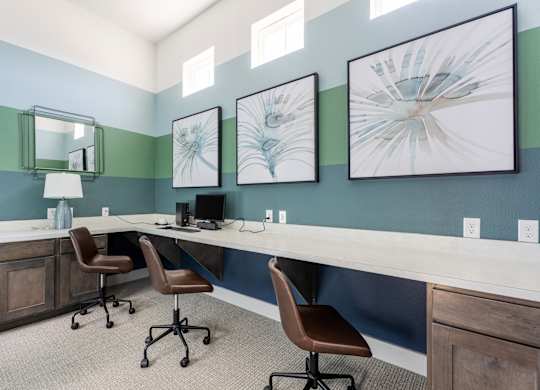 A room with a desk and chairs.