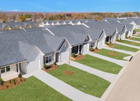A row of houses with a clear blue sky above them.