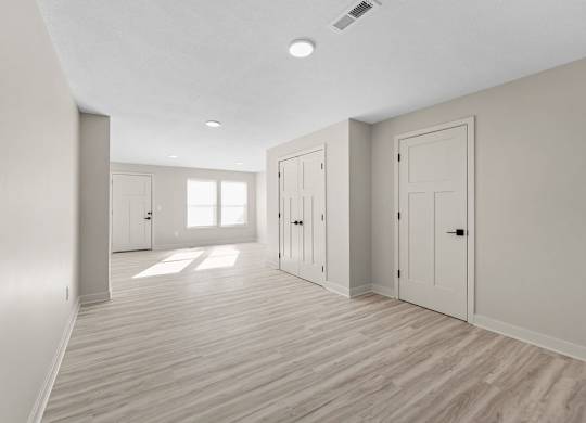 A room with wooden floors and white walls.