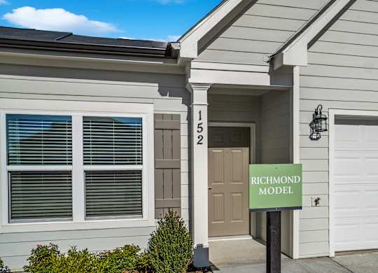 A house with a sign that says Richmond Model.