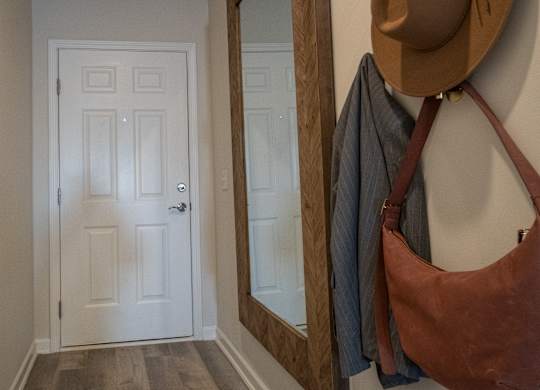 A white door with a mirror above it.