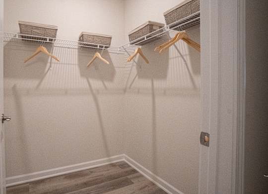 Walk-in closet in primary bathroom/bedroom