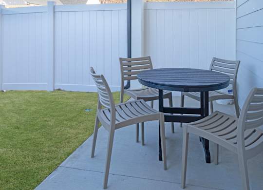 A table and chairs set up on a patio.