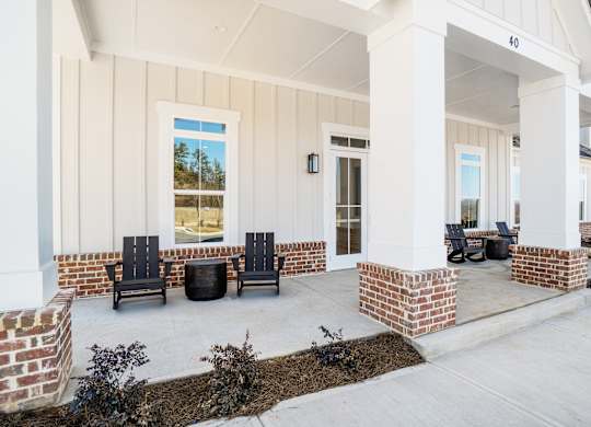 A house with a porch and a brick column.