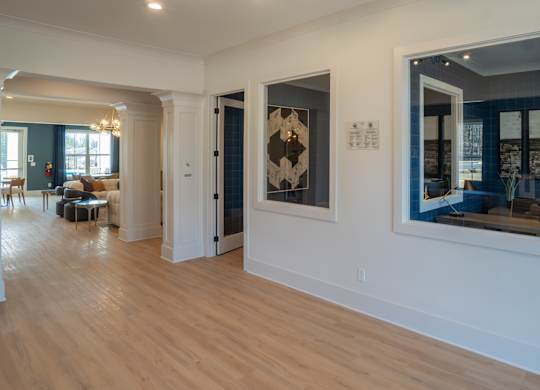 A spacious room with wooden floors and white walls.