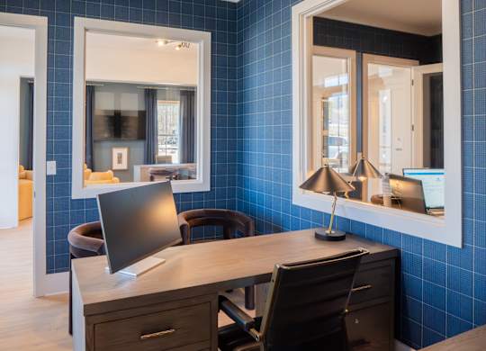 A room with a desk and a chair.