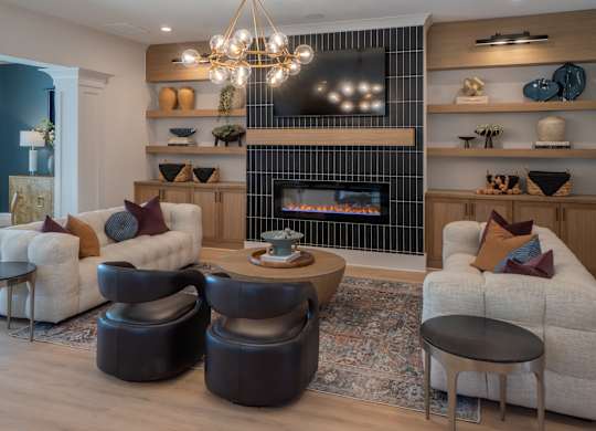 A living room with a fireplace and a TV above it.