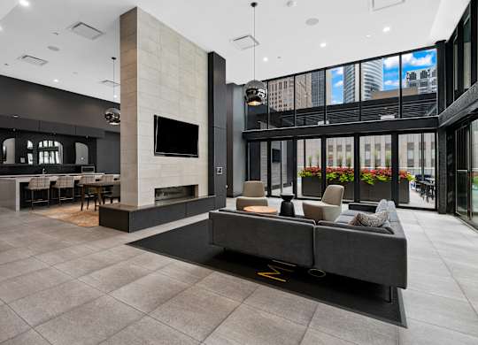 A modern living room with a grey sofa and a television.