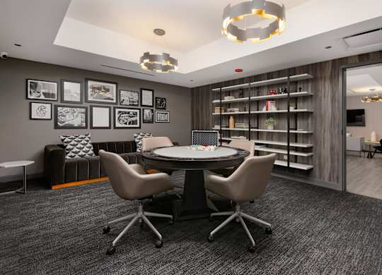 A conference room with a table, chairs, and pictures on the wall.