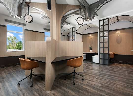 A modern office space with a curved desk and chairs.