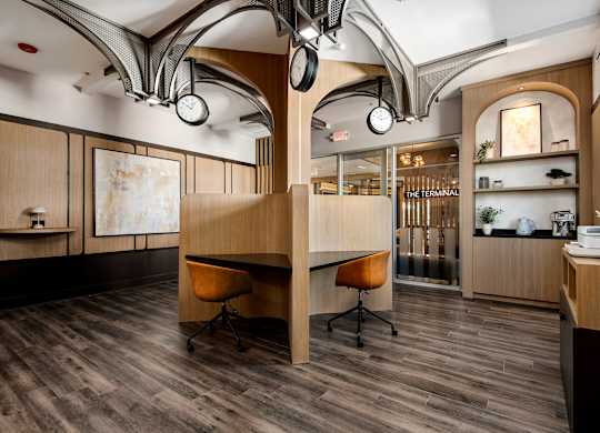 A modern office space with wood floors and furniture.