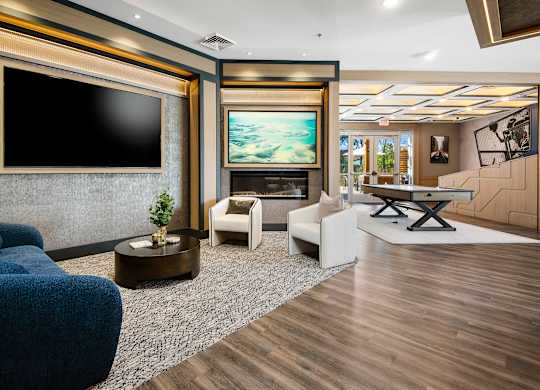 A modern living room with a blue sofa and a television.