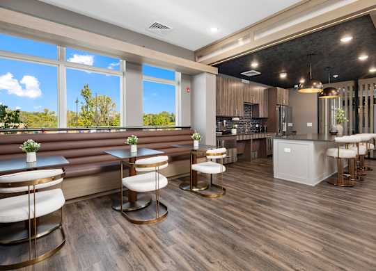 A modern bar area with wooden floors and a large window.