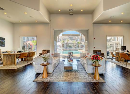 A living room with a large window and a view of the city.