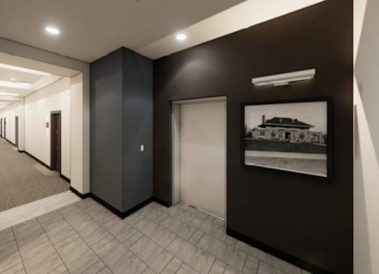 A long hallway with doors on both sides and a picture on the wall.
