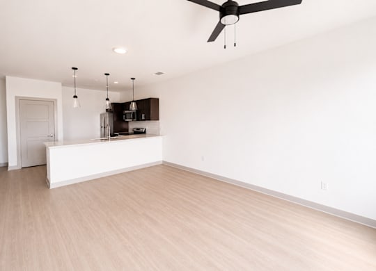A room with a ceiling fan and light fixture.