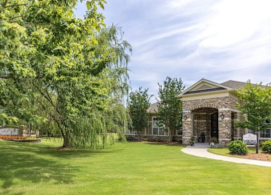 A building with a green lawn in front of it.