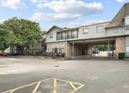 A parking lot with a building in the background.
