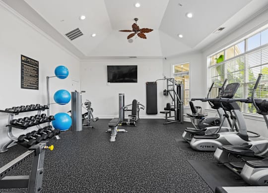 A spacious home gym with a variety of exercise equipment.