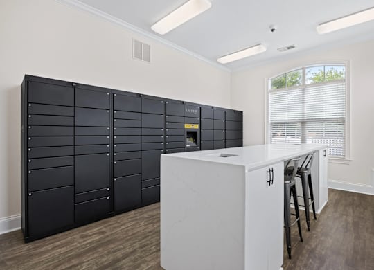 A kitchen with a white counter and black cabinets.