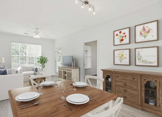 A dining room with a wooden table set for two.