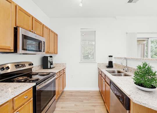 A kitchen with wooden cabinets and a white countertop.