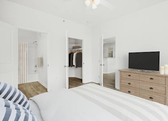 A bedroom with a bed, dresser, and mirror.