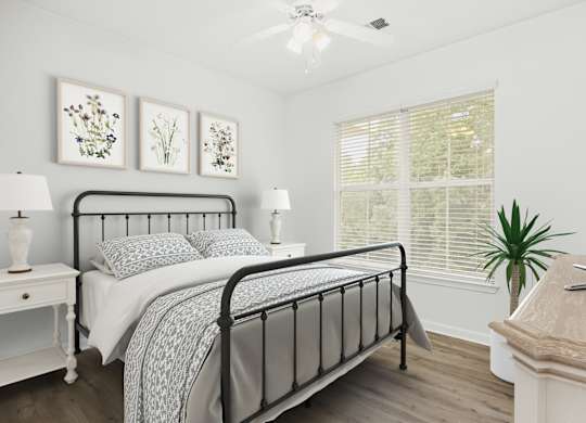 A bedroom with a bed, nightstand, and a television.