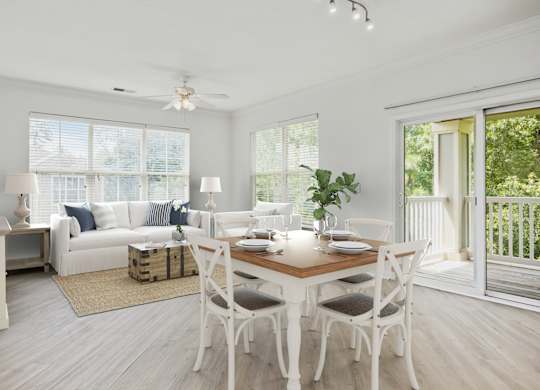 A dining room with a white table and chairs.