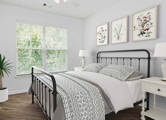 A bedroom with a large bed and a window with blinds.