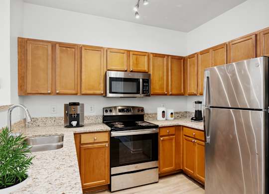 A kitchen with wooden cabinets and stainless steel appliances.