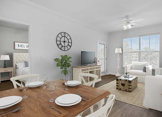 A dining room with a wooden table set for two.