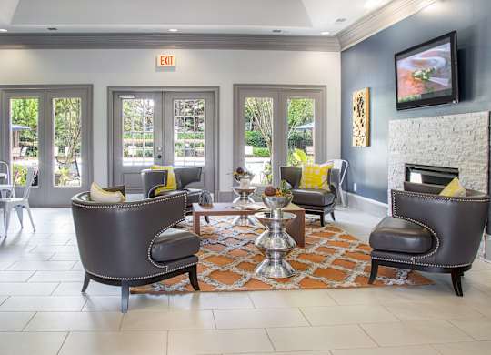 A living room with a fireplace and a TV mounted on the wall.