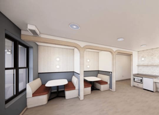 A kitchen area with a sink, stove, and cabinets.