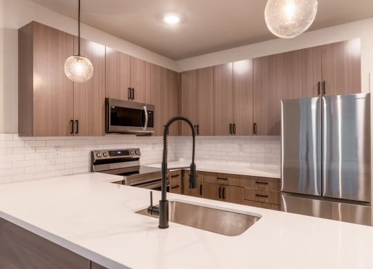 Townhouses For Rent In Raymore - Designer Kitchens With Island, Pantry, Quartz Countertops, Stainless Steel Samsung Appliances, Built-In Microwave, And Soft Close Cabinetry.