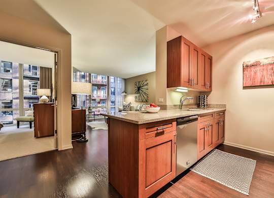 A kitchen with wooden cabinets and a stainless steel refrigerator.