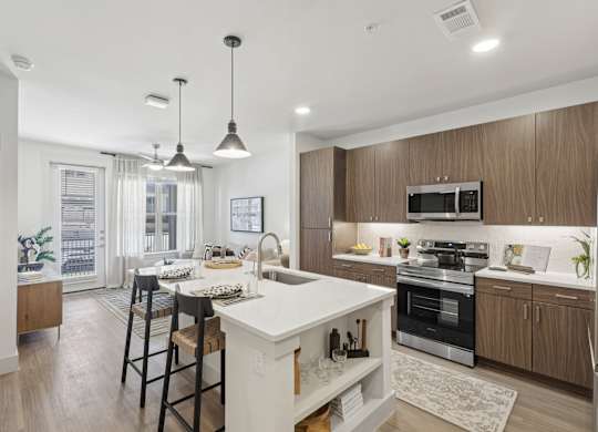an open kitchen and dining area with a white island and wooden cabinets