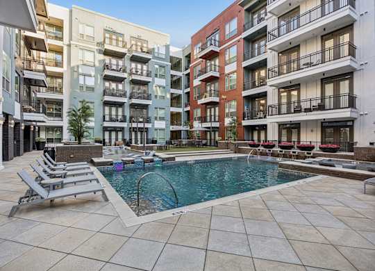 A swimming pool surrounded by lounge chairs at L2 Uptown in Dallas Texas