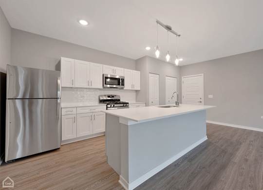 Apartment Kitchen with Island and Stainless Steel Appliances
