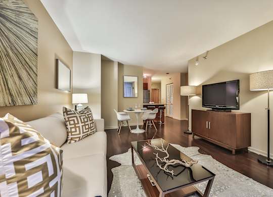 A living room with a white couch and a television.
