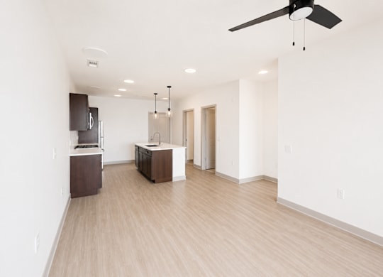A room with a ceiling fan and lighting fixtures.