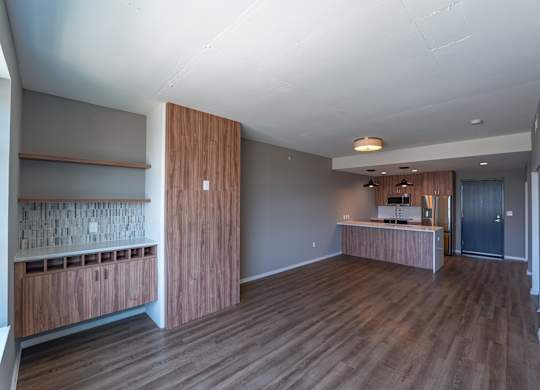 A room with wooden floors and a counter with a sink.