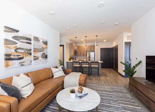 a living room with white walls and a brown couch